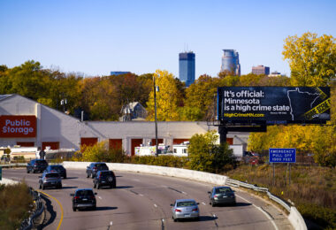 A billboard by a self described "leading public policy organization" at the I-94 Minneapolis border declares “It’s official” and directs motorists to a page where their interpretation of crime data shows crime rising years prior to the mass quitting of police officers in 2020-22.