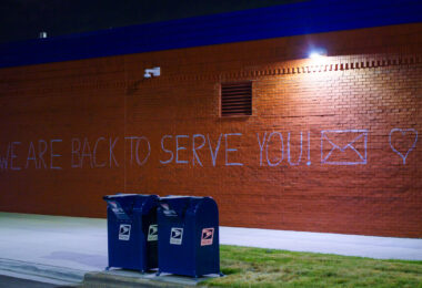 "We are back to serve you!" written on the side of the newly opened Lake Street Station. The post office was burned down during protests that followed the May 25th, 2020 murder of George Floyd.