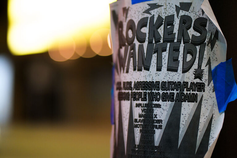 Heavy-Metal Guitarist Wanted Flyer in Downtown Minneapolis 4 A flyer taped to a pole in downtown Minneapolis advertises a search for an “aggressive guitar player” and “people who give a damn,” echoing the recruitment style of 1980s metal bands. The poster lists influences ranging from Vixen and Madam X to Mötley Crüe, Poison, Ratt, and Judas Priest—names that shaped the Twin Cities’ hard-rock and glam-metal culture during the era of small clubs and independent bands. Its DIY design and bold typography reflect the ongoing tradition of grassroots music promotion that still surfaces in the city’s urban corridors.