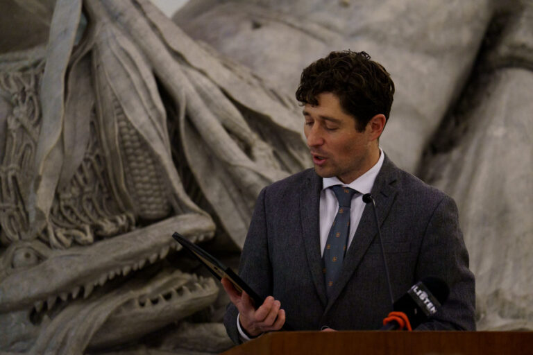 Mayor Jacob Frey at Minneapolis City Hall for George Floyd Day 3 Mayor Jacob Frey of Minneapolis stands at a podium in Minneapolis City Hall, proclaiming it George Floyd Day on what would have been Floyd’s 49th birthday. The proclamation occurred in the aftermath of the widespread protests and civil unrest that followed George Floyd's murder in May 2020. Minneapolis City Hall, a historic Beaux-Arts building completed in 1909, serves as the seat of the city's government and a site for significant civic events.