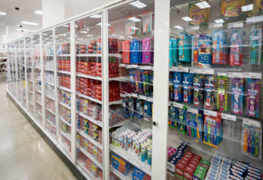 Personal-care items—including toothpaste, toothbrushes, and other everyday hygiene products—sit behind locked Plexiglas cabinets at the Target flagship store in downtown Minneapolis. In recent years, large retailers across U.S. urban centers have expanded the use of secured cases for small, easily resold goods in response to rising shrink and merchandise loss. At this location, much of the oral-care section now requires staff assistance to access, reflecting a broader shift in store security strategies and retail operations in high-traffic downtown corridors.