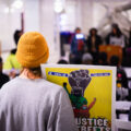 A protester holds up a sign reading “No Justice No Streets” as the Mayor Jacob Frey proclaims it George Floyd Day. It would have been Floyd’s 49th birthday.