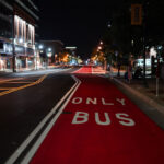 Red Bus Lane on Chicago Avenue at Nigh 4 A dedicated red bus-only lane runs along Chicago Avenue in Minneapolis, part of the city’s recent investments in transit priority corridors. These painted lanes are designed to give buses consistent travel times through dense urban segments, especially during peak hours, and they align with regional plans to improve service reliability on key north–south routes. Late at night the corridor is quiet, with the reflective pavement markings and overhead lighting emphasizing the straight line of the transit path through the Midtown area.