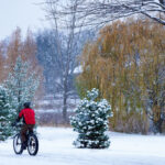 Biker in the snow riding on Lake of the Isles in Minneapolis 1 A biker on Lake of the Isles in Minneapolis during the seasons first snowfall.