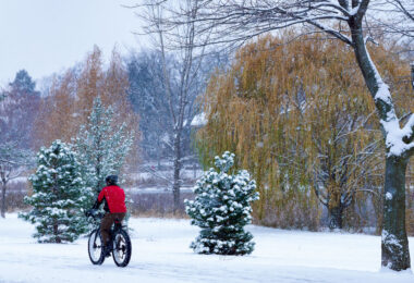 A biker on Lake of the Isles in Minneapolis during the seasons first snowfall.