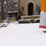 Giant Pencil Sculpture Near Lake of the Isles 1 A large pencil sculpture stands partly buried in fresh snow near Lake of the Isles in Minneapolis. The piece—well-known to neighborhood walkers and cyclists—sits on the lawn of a private residence and has become a quiet local landmark. Framed by stone steps, evergreens, and early-season snowfall, it reflects the eclectic public-facing art found throughout the surrounding residential areas of the Chain of Lakes.