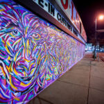 A new mural from Jimmy Longoria wraps around the Chicago-Lake Liquors building and covering the front metal shutters.