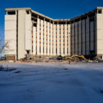 Demolition of Vacant Office Tower in Bloomington 4 A partially dismantled mid-century office tower stands open to the winter light in Bloomington, Minnesota, as demolition crews continue taking down the long-vacant structure. The building’s exposed interior and collapsed debris field reflect the broader wave of suburban redevelopment that has reshaped commercial corridors near I-494 and the Minneapolis–St. Paul International Airport. Heavy equipment rests at the base of the tower, marking another step in clearing the site for future use amid changing regional land-use patterns.