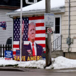 Save America Trump House, Wisconsin 1 Honk For Tronk, Let's Go Brandon, Dont Blame Me I Voted For Trump, Back The Blue, and a portrait of Donaldl Trump signs on a Wisconsin home.