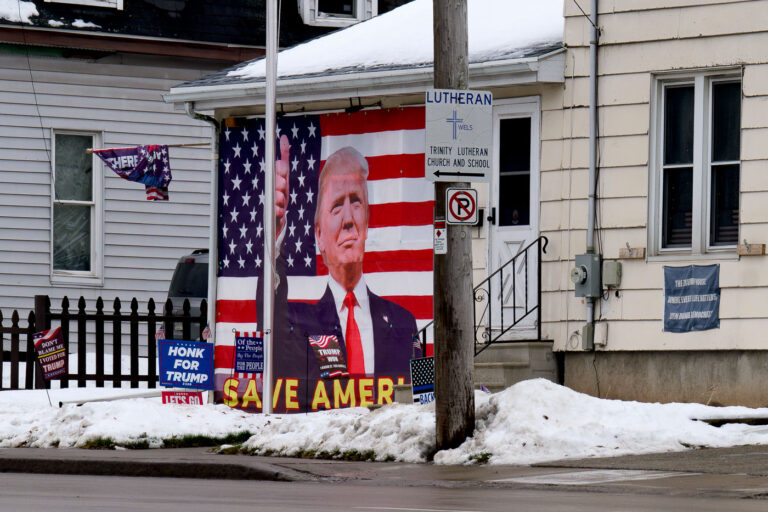 Save America Trump House, Wisconsin 1 Honk For Tronk, Let's Go Brandon, Dont Blame Me I Voted For Trump, Back The Blue, and a portrait of Donaldl Trump signs on a Wisconsin home.