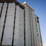 Southgate Office Tower Before Demolition 3 The Southgate Office Tower in Bloomington, Minnesota, stands with its vertical concrete panels and boarded-up windows in the final weeks before demolition. Built in the 1960s as part of a broader commercial corridor near I-494 and Portland Avenue, the building had become long vacant by the 2010s. Its distinctive mid-century façade—once a recognizable landmark for drivers on the interstate—shows stripped interiors and exposed structural elements as crews prepare the site for redevelopment.