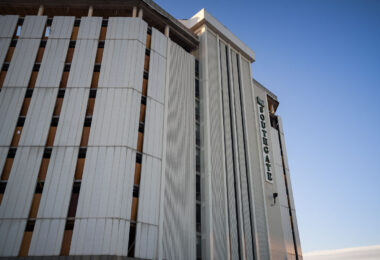 The Southgate Office Tower in Bloomington, Minnesota, stands with its vertical concrete panels and boarded-up windows in the final weeks before demolition. Built in the 1960s as part of a broader commercial corridor near I-494 and Portland Avenue, the building had become long vacant by the 2010s. Its distinctive mid-century façade—once a recognizable landmark for drivers on the interstate—shows stripped interiors and exposed structural elements as crews prepare the site for redevelopment.