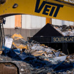 Southgate Tower Demolition in Bloomington 4 Construction equipment and twisted debris surround the former Southgate entrance canopy as crews continue dismantling the long-vacant tower near I-494 in Bloomington, Minnesota. The Southgate complex, once part of a mid-century office corridor, is being cleared after years of declining occupancy, making way for new redevelopment in one of the metro’s busiest commercial zones. The exposed framework and scattered metal panels highlight the final stages of the structure’s removal.
