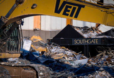 Construction equipment and twisted debris surround the former Southgate entrance canopy as crews continue dismantling the long-vacant tower near I-494 in Bloomington, Minnesota. The Southgate complex, once part of a mid-century office corridor, is being cleared after years of declining occupancy, making way for new redevelopment in one of the metro’s busiest commercial zones. The exposed framework and scattered metal panels highlight the final stages of the structure’s removal.