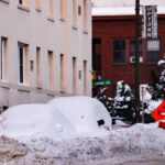 Cars under the snow following a 14" snowfall in Uptown Minneapolis.