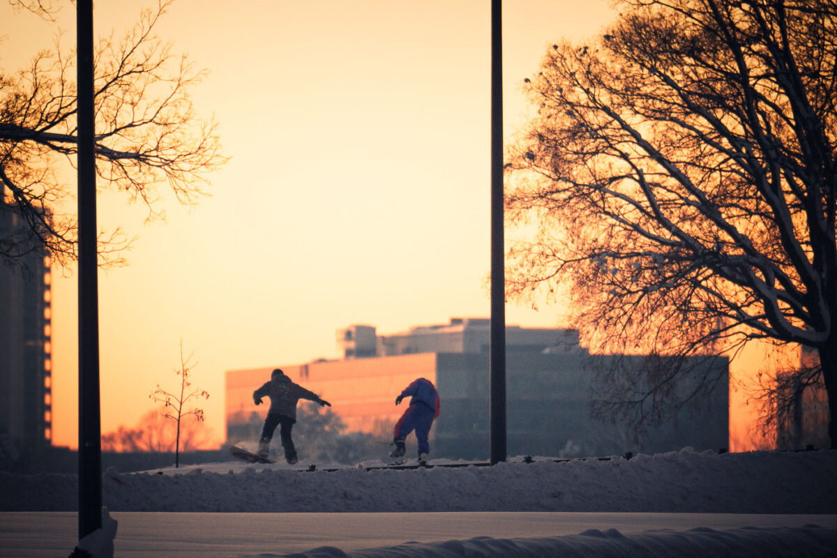 Snowboarders in Minneapolis after a large snowfall.