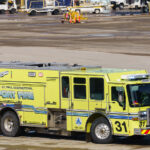 Airport Fire truck at MSP Airport 3 A Minneapolis–St. Paul International Airport fire truck, painted in its distinctive lime-yellow livery, is seen positioned on the tarmac. Marked “Airport Fire” and operated by the Metropolitan Airports Commission, the truck is equipped for rapid response to aircraft and runway emergencies. Its specialized design includes high-capacity foam systems and reinforced compartments for rescue tools, reflecting the critical role of airport fire units in ensuring safety across one of the Midwest’s busiest aviation hubs.