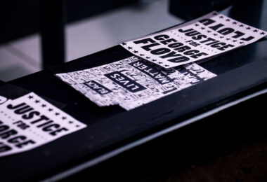 "Justice for George" stickers in a storefront on Hennepin Avenue in Uptown Minneapolis.