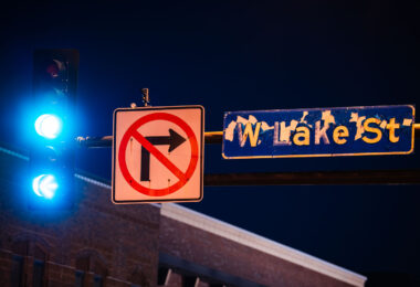 W. Lake St. sign on Hennepin Ave in Uptown Minneapolis. The paint peeling from burning dumpsters during unrest following the law enforcement killing of Winston Smith in June 2021.