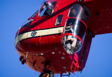 A heavy-lift Sikorsky S-64 Skycrane Helicopter in downtown Minneapolis bringing HVAC materials to the US Bank Plaza roof.
