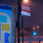 A mural on the side of a building on East Lake Street. The building across from the Minneapolis Police third precinct survived the riots. Minnehaha Liquors was not as lucky, however the sign remains.