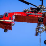 A heavy-lift Sikorsky S-64 Skycrane Helicopter in downtown Minneapolis bringing HVAC materials to the US Bank Plaza roof.