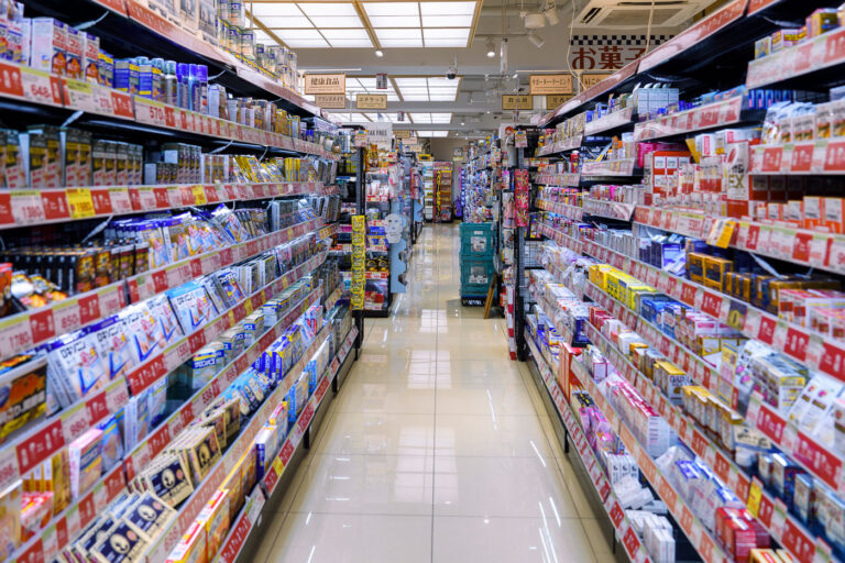 Aisles Inside a Tokyo Convenience Store 3 A well-stocked aisle inside a convenience store in Tokyo, photographed in March 2023. Japan’s major chains—such as Lawson, FamilyMart, and 7-Eleven—are known for their dense product layouts, where shelves are filled with everything from health supplements and over-the-counter medicines to snacks, instant meals, and travel essentials.Convenience stores, or konbini, have played an important role in daily urban life since rapid expansion in the 1980s, providing reliable 24-hour access to food, bill-paying services, parcel pickup, and seasonal goods. Their efficient layouts and constant product rotation reflect Japan’s retail culture, where limited-edition items, regional flavors, and promotional displays are updated weekly to match demand and maximize shelf use.