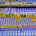 A densely stocked battery display inside Yodobashi Camera’s Shinjuku complex in March 2023. Yodobashi’s in-house battery line is prominently featured, with signage advertising long shelf-life options—10-year storage for premium models and 5-year storage for standard packs. Clear price labeling, bulk multi-pack options, and emergency-preparedness messaging reflect the store’s emphasis on reliability and daily-use electronics.

Yodobashi Camera Shinjuku is one of Tokyo’s largest electronics hubs, spanning multiple buildings near the west exit of Shinjuku Station. Its battery aisles exemplify the retailer’s merchandising style: bright color-coded labels, multilingual product cues, and high-volume stock arranged for quick comparison by commuters and tourists alike.