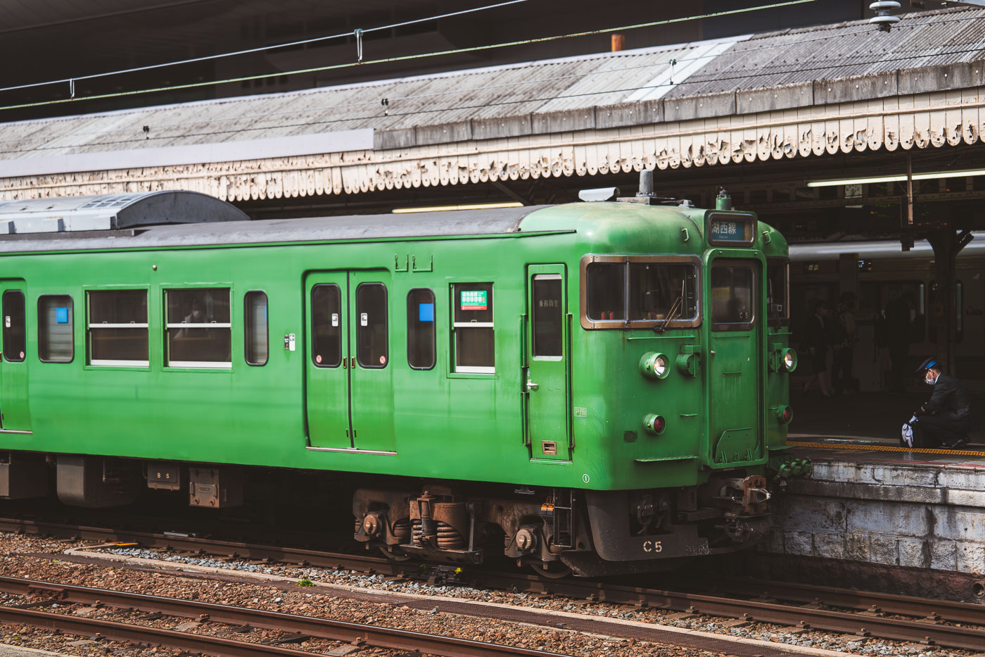 classic green Japanese commuter train in Kyoto