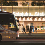 Evening Bus Terminal at Shinjuku Station 1 Intercity buses line up outside Shinjuku Station in Tokyo, one of the busiest rail hubs in the world and a major transfer point for long-distance coach services. The station’s west side is home to a dense cluster of express bus platforms that connect Tokyo with destinations across Honshu, Hokkaido, and Kyushu.
Captured in March 2023, the photo shows the steady flow of evening commuters moving between the station concourse and the bus loading area, illuminated by the station’s modern façade lighting. The scene reflects Shinjuku’s role not only as a metropolitan transit hub but also as a key gateway for regional travel throughout Japan.