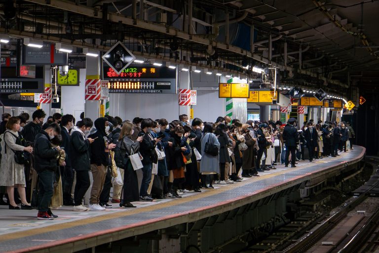 Evening Rush Hour, Shinjuku Station Platform, Tokyo 2 Commuters wait on a Japanese train platform during evening rush hour.