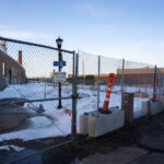 Fenced off Roof Depot building in South Minneapolis as seen from the Midtown Greenway.