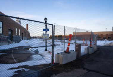 Fenced off Roof Depot building in South Minneapolis as seen from the Midtown Greenway.