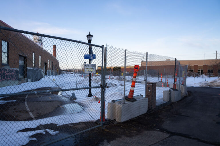 Fencing around the Roof Depot 3 Fenced off Roof Depot building in South Minneapolis as seen from the Midtown Greenway.