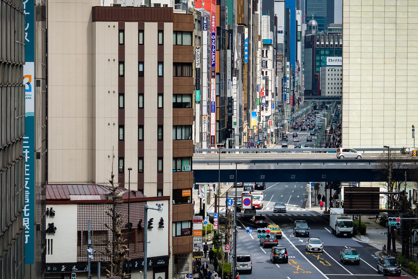 Ginza street view, Tokyo, Japan, showing a busy commercial district with traffic and pedestrians.