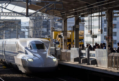 An N700A-series Shinkansen arrives at Kyoto Station, one of the busiest hubs on the Tōkaidō and San’yō Shinkansen network. Introduced by JR Central as an upgraded variant of the earlier N700 design, the N700A incorporated improved braking, enhanced bogies, and automatic train control refinements, supporting smoother high-speed operation along Japan’s primary intercity corridor.

Kyoto Station has served Shinkansen services since 1964, when the original Tōkaidō Line opened for the Tokyo–Osaka route ahead of the Tokyo Olympics. Today it remains a major interchange for regional and long-distance rail, handling millions of passengers annually traveling between Kansai, Tokyo, and the Chūgoku region.