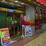 Pachinko parlors remain a defining part of Japan’s postwar entertainment landscape, evolving from small mechanical game halls into large, brightly lit venues that line the streets of major cities. This Shinjuku location reflects the modern industry’s mix of gambling-adjacent gaming, animated advertising, and elaborate storefront displays designed to attract commuters and tourists.

Although pachinko operates in a legal gray zone—winnings are exchanged off-site to comply with gambling regulations—it has grown into a multibillion-yen sector with deep cultural roots, from the machines’ lineage in early 20th-century children’s games to their present role as a staple of urban nightlife.