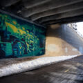 A train mural by Reggie LeFlore on the Midtown Greenway in South Minneapolis.