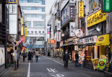 Sanbangai Street sits just west of Shinjuku Station and is part of the dense network of narrow commercial lanes that define this section of the city. The area developed rapidly after the mid-20th-century reconstruction of Shinjuku and is now lined with small restaurants, curry shops, bars, and specialty eateries catering to commuters and office workers moving through the station district each day.

The nearby Shinjuku Post Office has long served as a recognizable landmark on the north side of the station, anchoring a neighborhood known for its mix of long-established storefronts and constantly rotating food businesses.