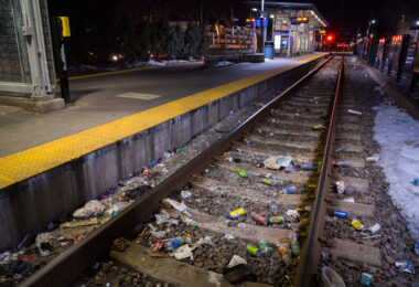 Discarded needles and trash line the tracks at the Cedar-Riverside LRT station.