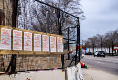 Flyers reading "WE REMEMBER GEORGE FLOYD. WE DEMAND ABOLITION." hang on the former burned Minneapolis police 3rd precinct after a week of what is being called "community conversations". City is asking for input on if a precinct should be rebuilt at same location or down the road.