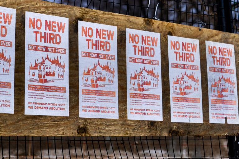 Minneapolis: Flyers protest proposed 3rd Precinct rebuild 2 Flyers protesting the proposed rebuilding of the Minneapolis Police Department's 3rd Precinct are displayed on a wooden structure. The flyers, which read "NO NEW THIRD. NOT NOW. NOT EVER." and "WE REMEMBER GEORGE FLOYD. WE DEMAND ABOLITION.", reference the precinct's destruction during the 2020 George Floyd protests. The city had been holding "community listening sessions" to gather input on whether to rebuild the precinct at its original location or elsewhere. The presence of these flyers highlights ongoing community sentiment and debate surrounding policing and public safety in Minneapolis.