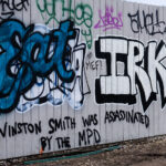 Graffiti reading "Winston Smith was assassinated by the MPD on the Cedar Lake Trail in April 2023.