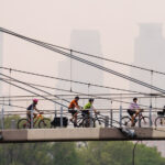 Bikers cross the Martin Olav Sabo Bridge in South Minneapolis as air quality alerts are issued due to drifting south Canadian wildfire smoke.