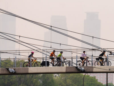 Bikers on Sabo Bridge amid Canadian wildfire smoke, Minneapolis