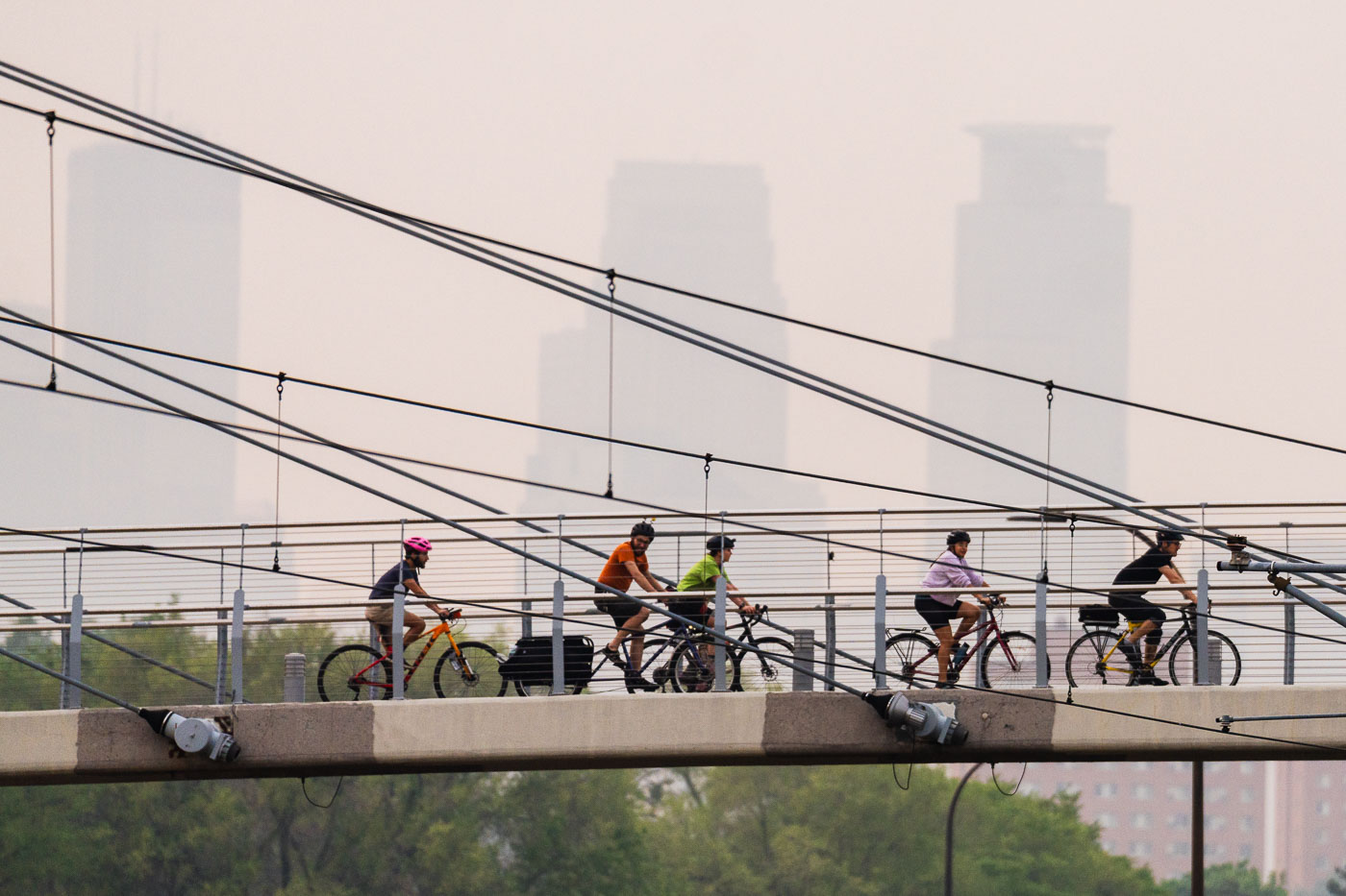 Bikers crossing bridge during air quality alerts in Minneapolis