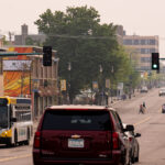 Hazy skies over Lake Street in South Minneapolis during bad air quality from Canadian wildfire smoke drifting south.