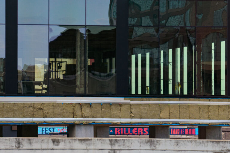 Killers Imagine Dragons seen through construction 1 Twins Fest signage as seen through new construction tower going up in the North Loop.