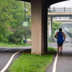 Biker and jogger on the Midtown Greenway in South Minneapolis as Canadian wildfire smoke hits the city.