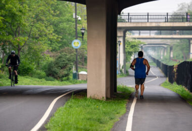 Biker and jogger on the Midtown Greenway in South Minneapolis as Canadian wildfire smoke hits the city.